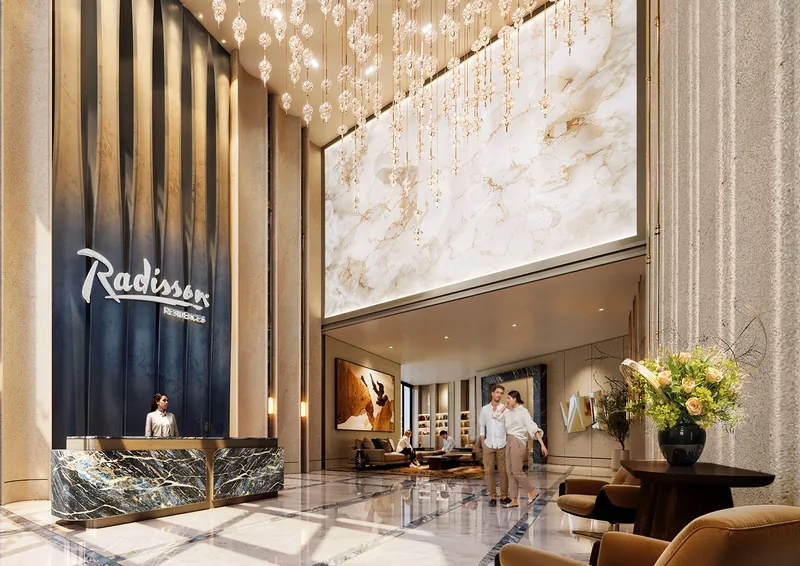 Double-height Radisson lobby with a marble feature wall
